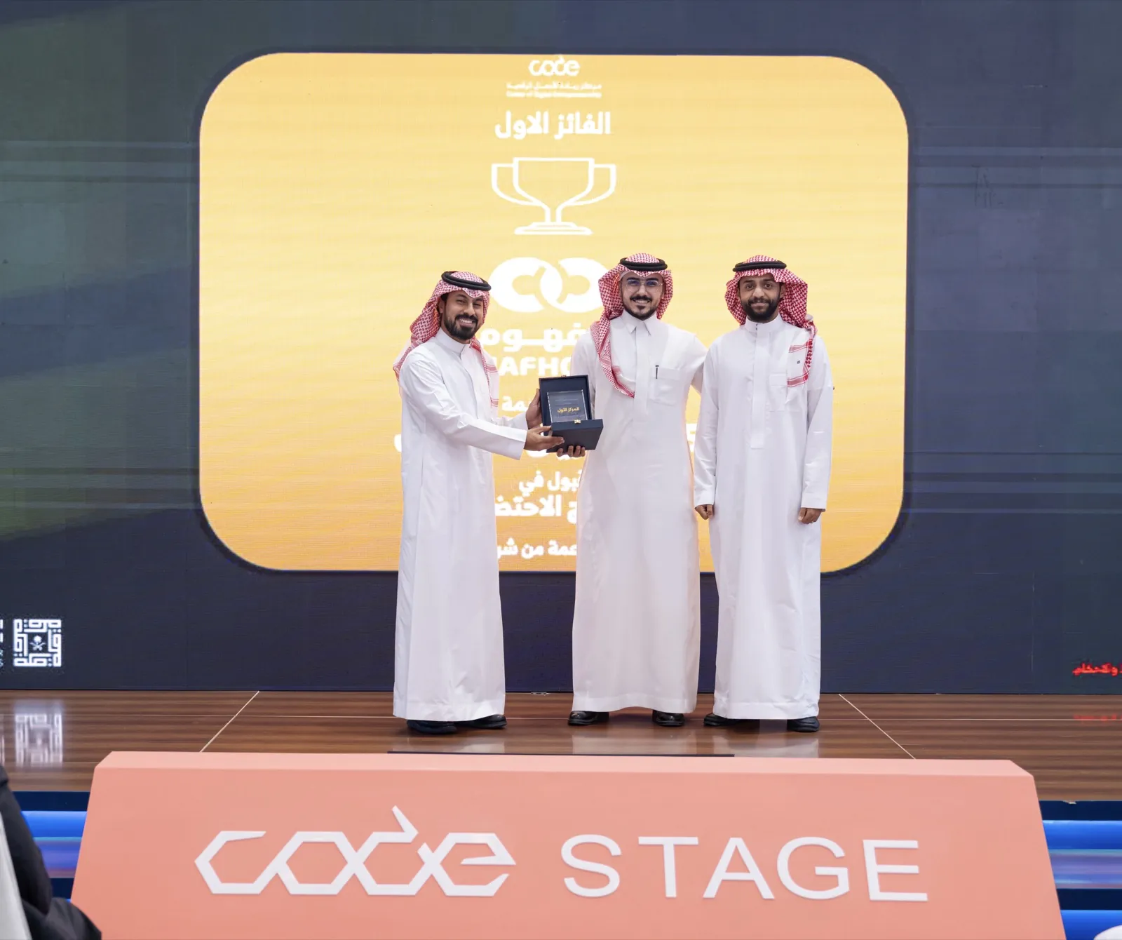 Mafhoom team members receiving the first-place award on the CODE stage